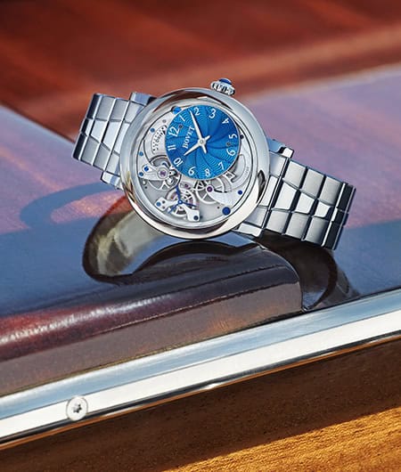 Elegant Bovet timepiece with a blue dial and skeleton design on a metal bracelet.