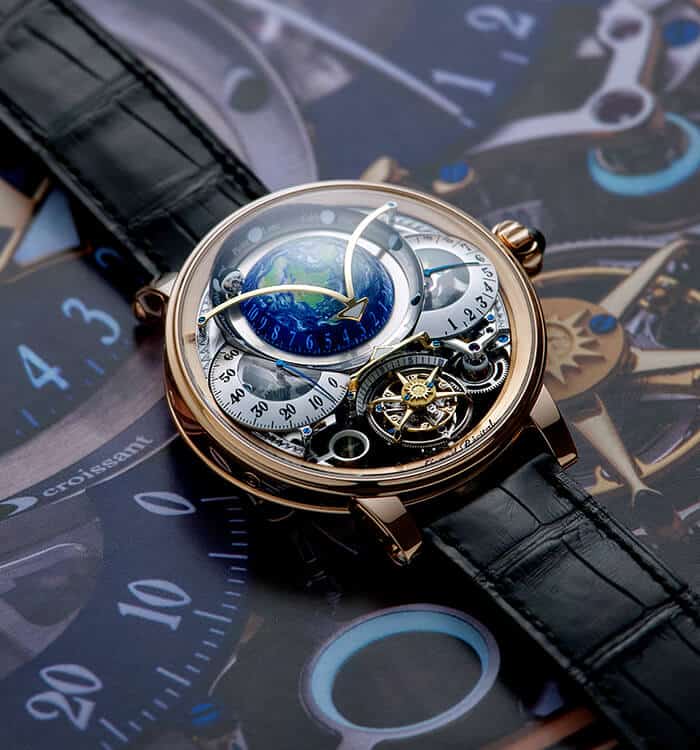 Earth-themed intricate timepiece with a black leather strap, showcasing complex mechanisms and celes.