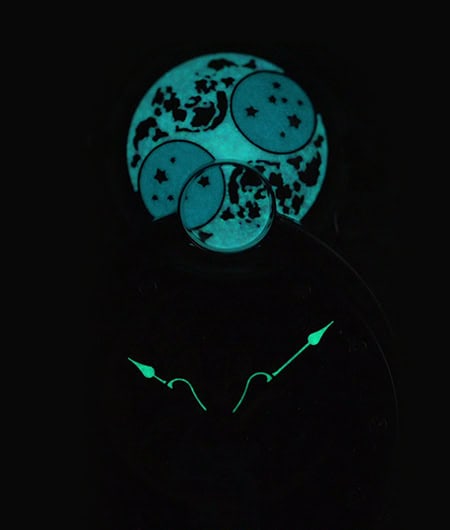 A luminous moon phase and celestial-themed timepiece with glowing elements, emphasizing intricate as.