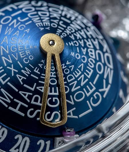 Intricate blue timepiece dial with world city names and gold hand detail.