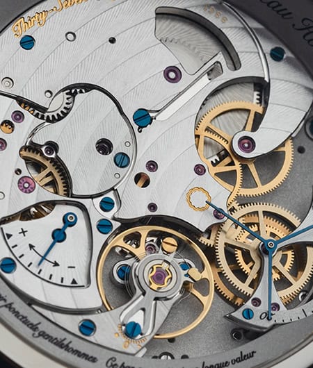 Intricate mechanical movement of a luxury timepiece with gold and blue accents.