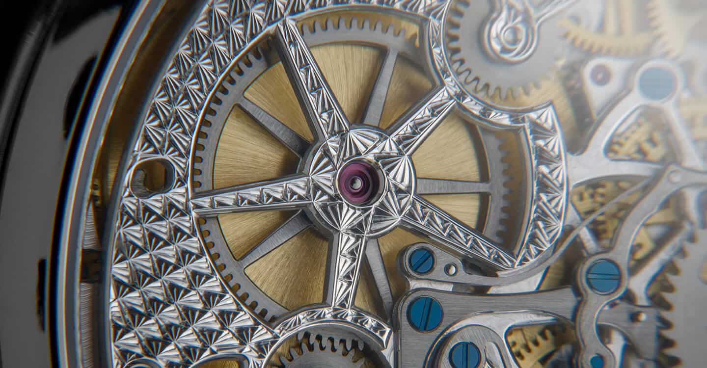 A detailed close-up of a Dimier Récital 28 timepiece showcasing intricate engravings and mechanical.