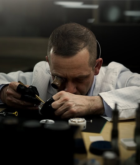 Expert watchmaker assembling a luxury timepiece with precision and care.