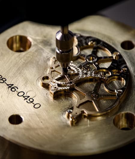 A detailed close-up of a mechanical timepiece movement showcasing intricate gears and components.