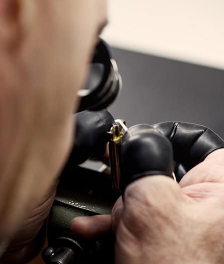 Expert craftsman assembling a luxury timepiece with precision and care.