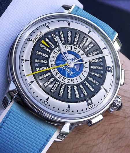 Elegant Dimier timepiece with world time display and blue accents, showcasing luxury craftsmanship.