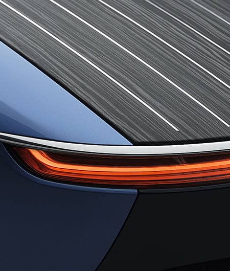 Elegant blue car with sleek design and LED lighting, highlighting luxury and craftsmanship.
