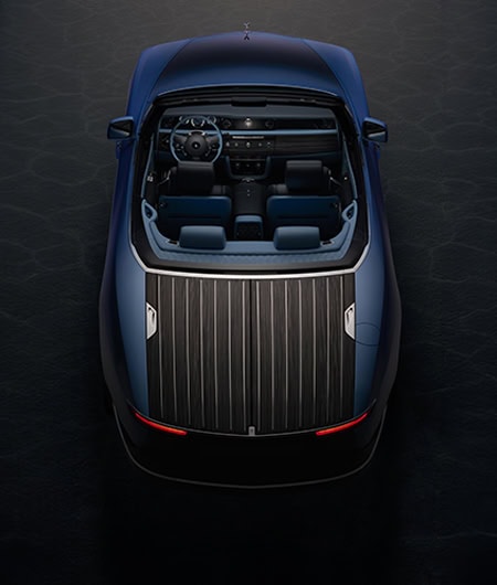 Luxurious blue vehicle with sleek interior and wooden deck, inspired by Fleurier - Rolls-Royce Boat.