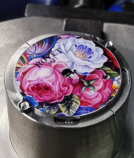 Luxurious floral-themed timepiece with intricate design and vibrant colors.