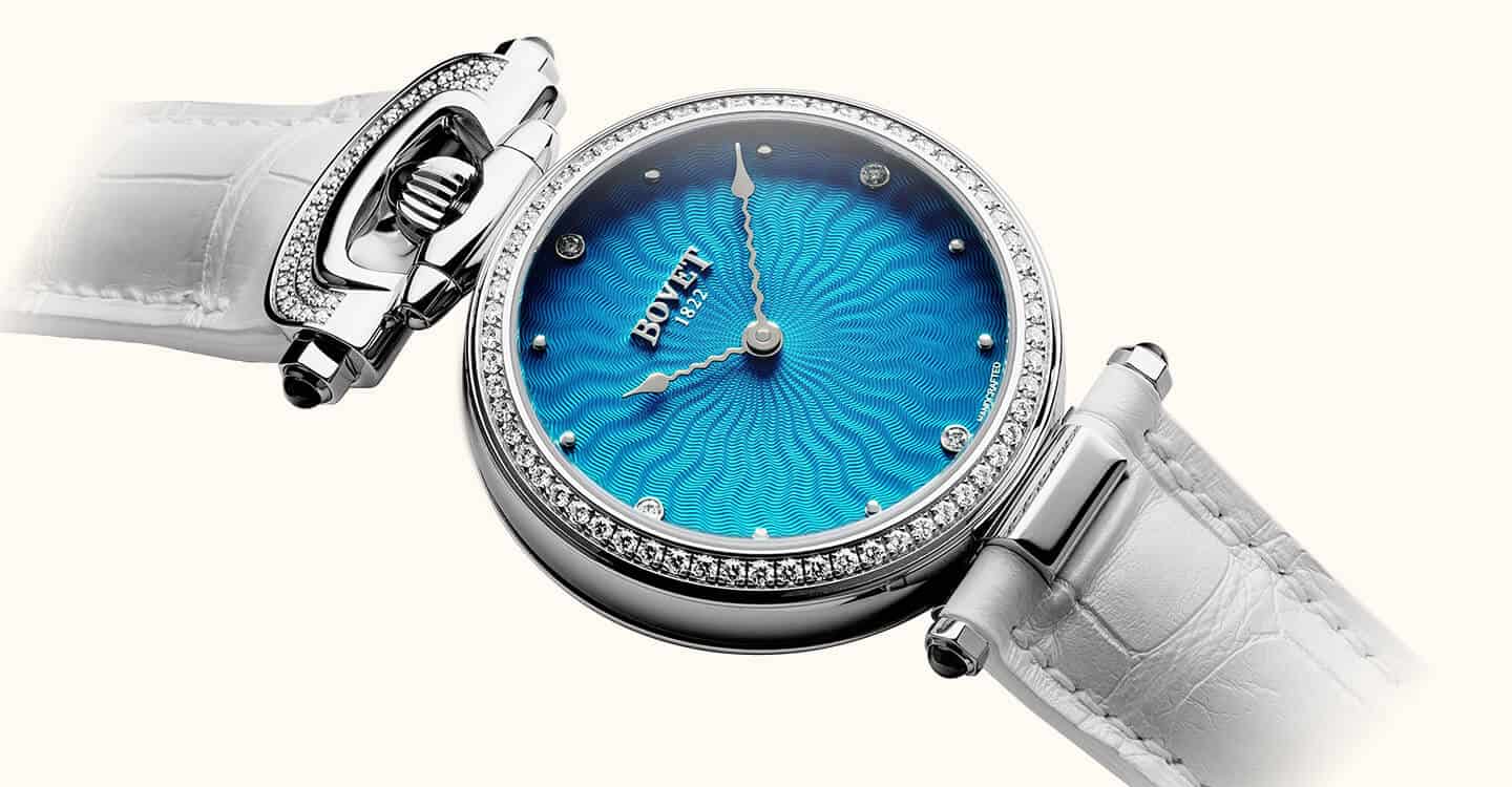 Elegant Bovet Fleurier Miss Audrey timepiece with a vibrant blue dial and diamond accents, showcasin.