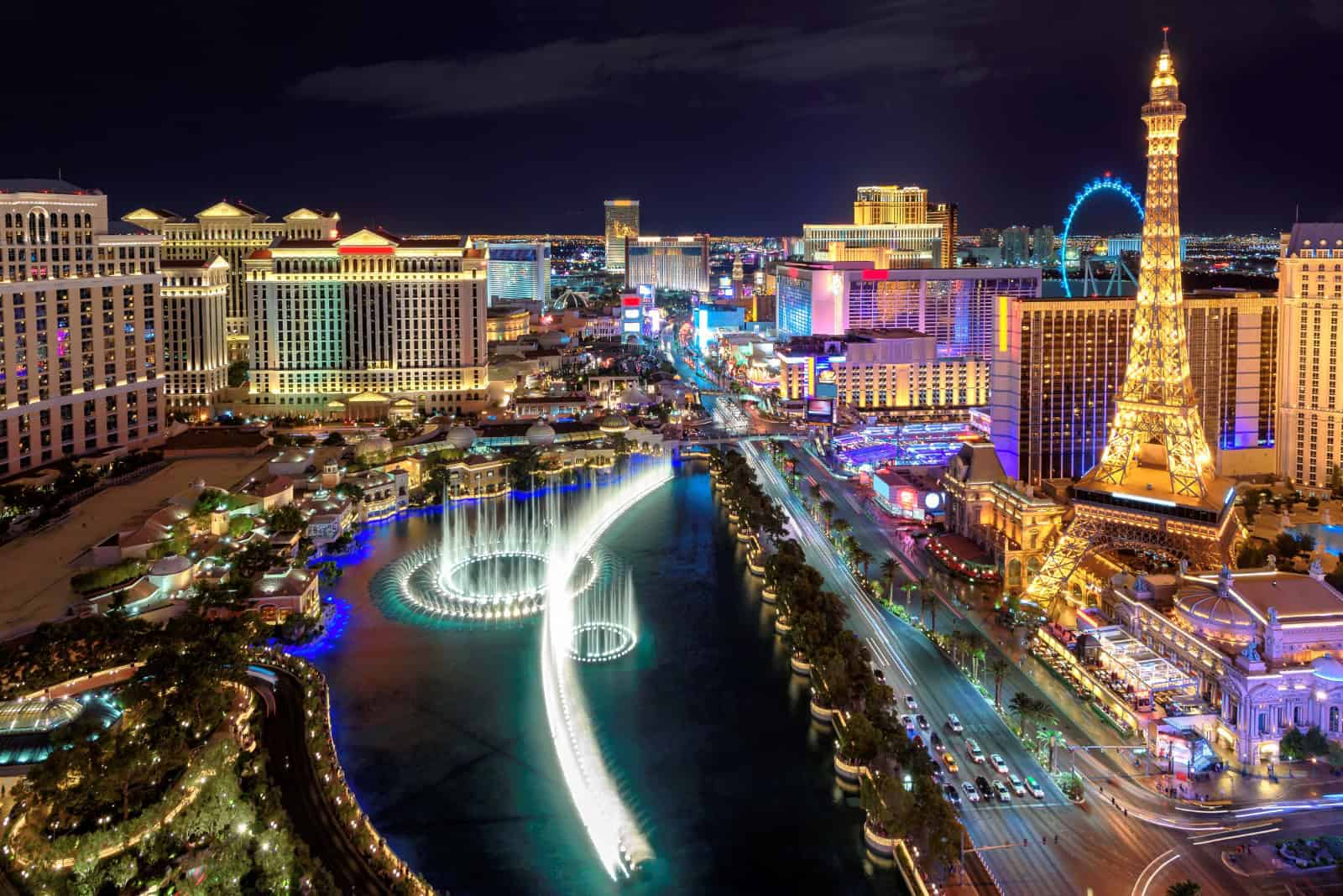 Elegant Las Vegas skyline illuminated at night, featuring the Eiffel Tower replica and vibrant city.