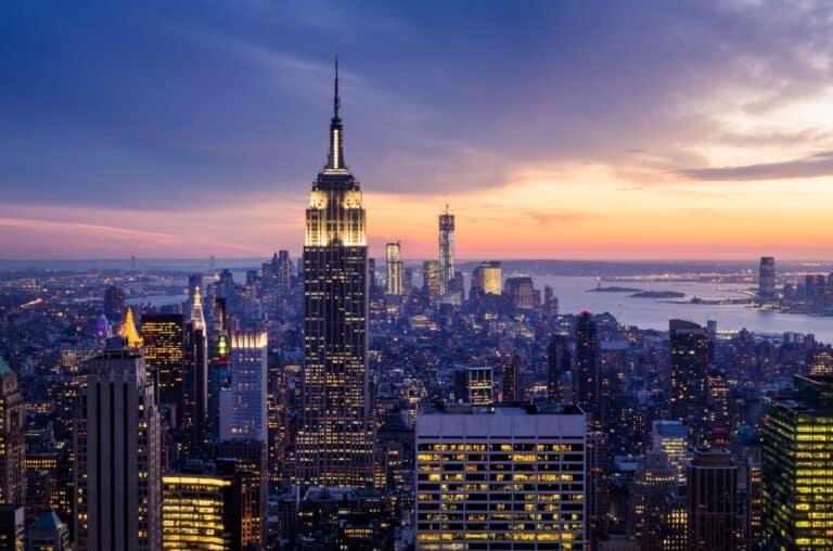 Empire State Building illuminated at sunset, showcasing luxury and craftsmanship in urban elegance.