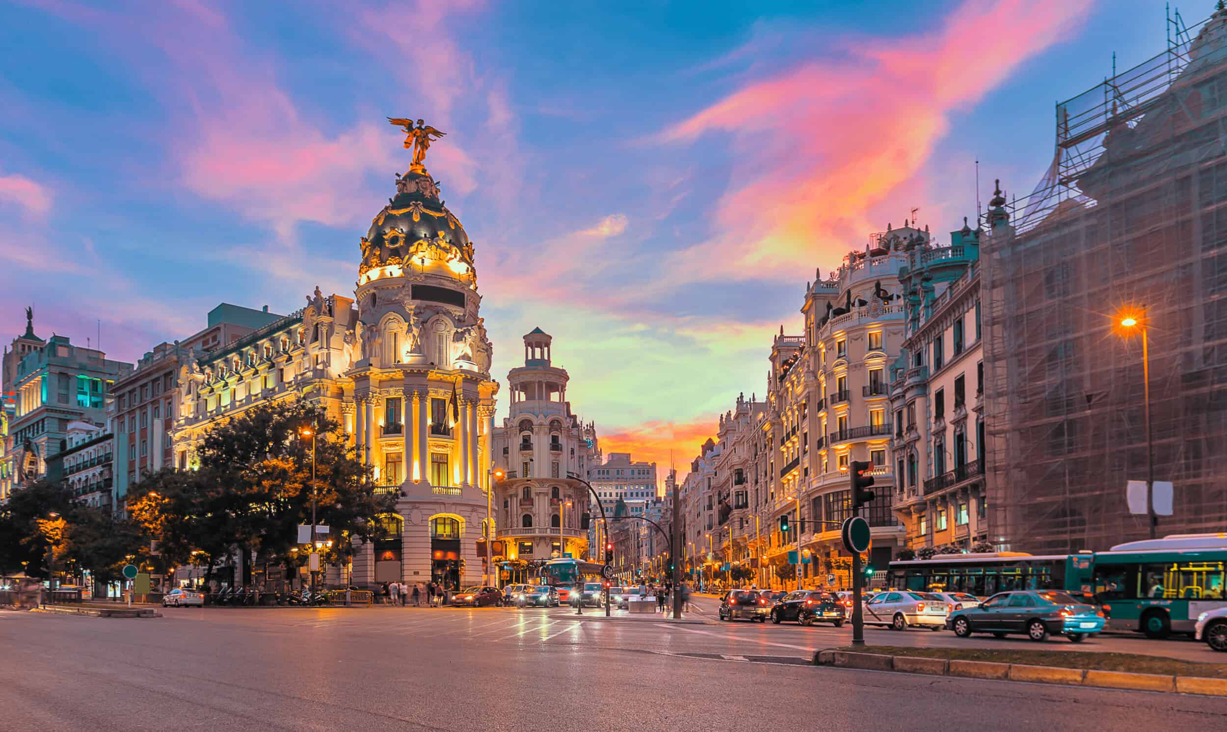 Elegant cityscape featuring historic architecture and vibrant sunset sky, highlighting luxury timepi.