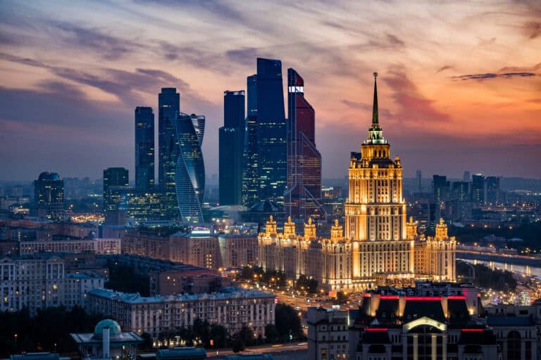 Iconic Moscow skyline featuring the BOVET building and modern skyscrapers at sunset.