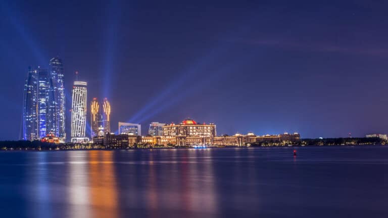 Elegant Dubai skyline illuminated at night, showcasing modern architecture and vibrant city lights.