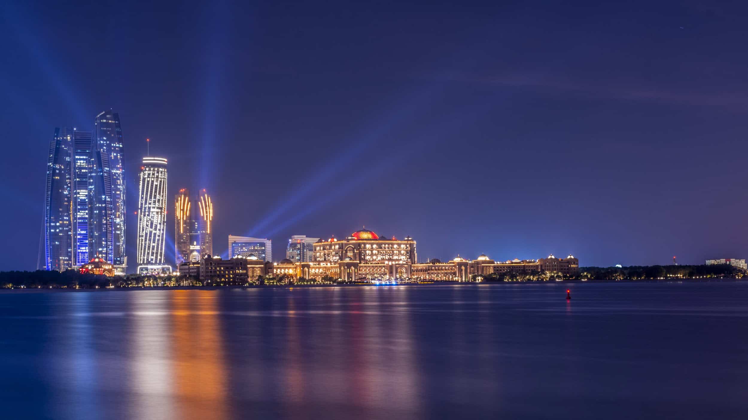 Elegant Dubai skyline illuminated at night, showcasing modern architecture and vibrant city lights.