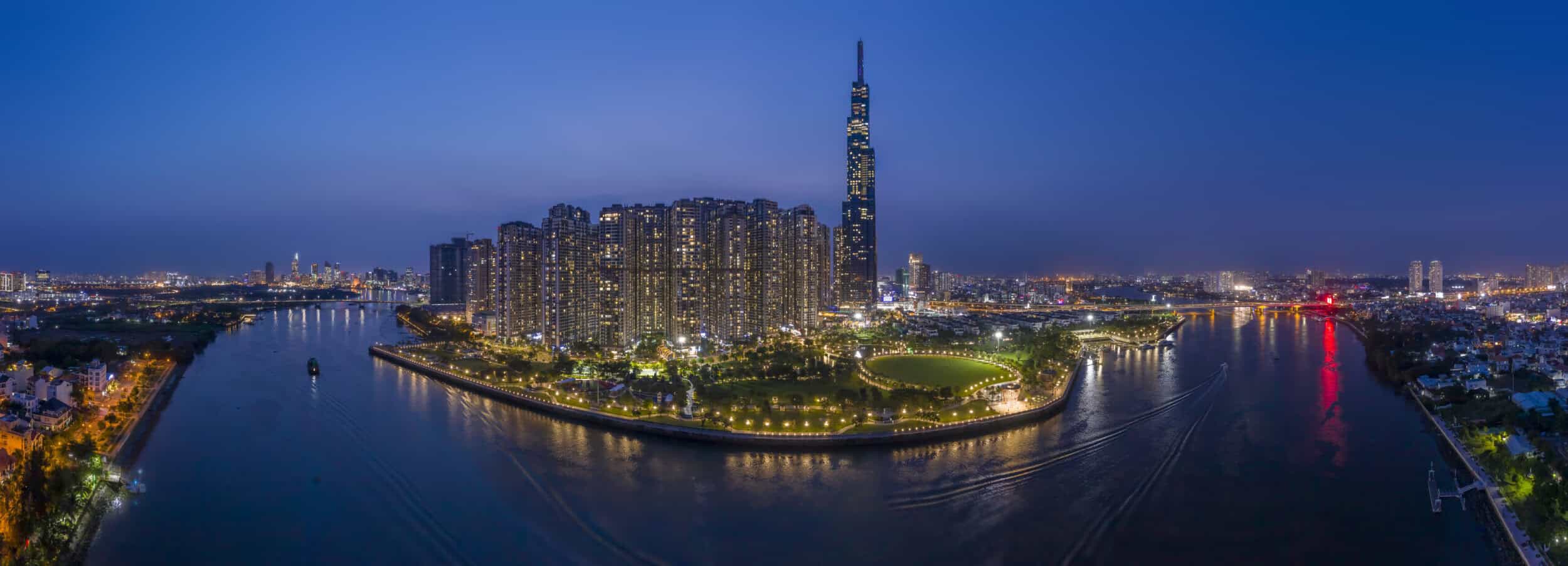 A panoramic view of Ho Chi Minh City skyline with the iconic Bitexco Tower and vibrant city lights a.