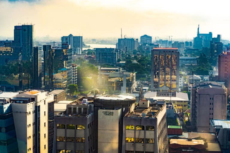 Modern cityscape with high-rise buildings and urban skyline at sunrise.