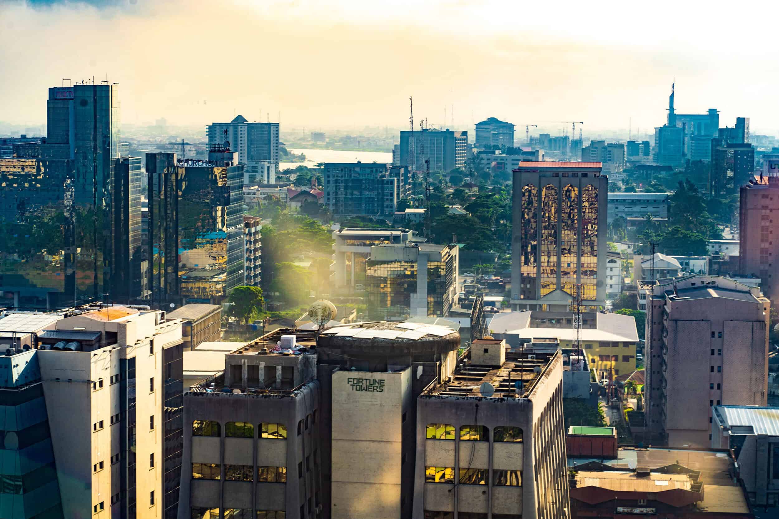 Modern cityscape with high-rise buildings and urban skyline at sunrise.