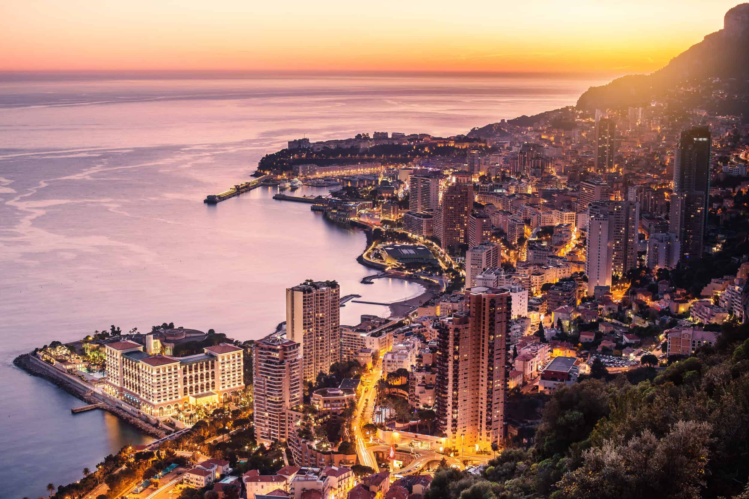 A stunning aerial view of Monte Carlo at sunset, highlighting the luxurious coastal cityscape and vi.