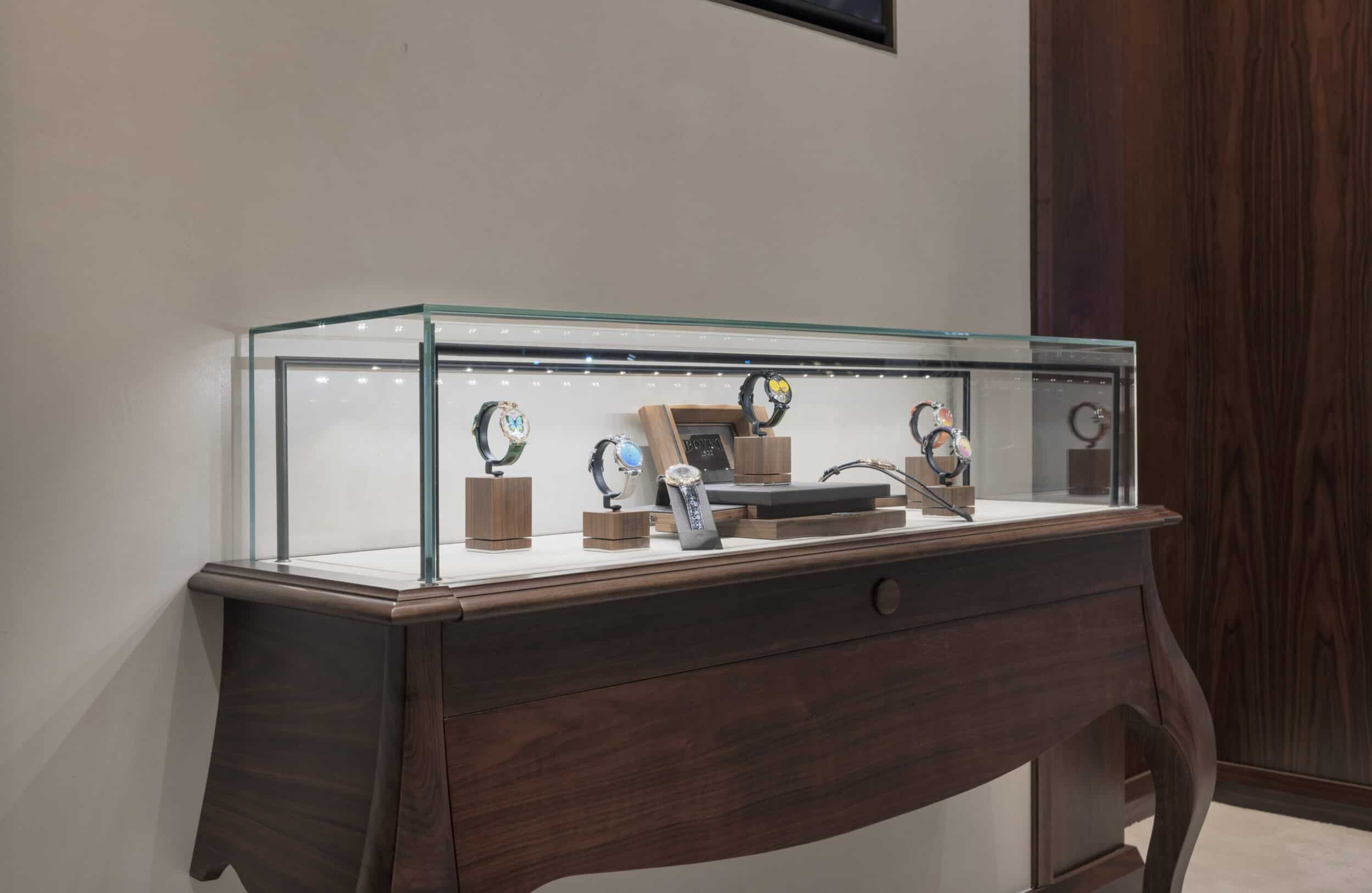 Elegant Bovet timepieces displayed in a glass case, showcasing craftsmanship and luxury in a refined.
