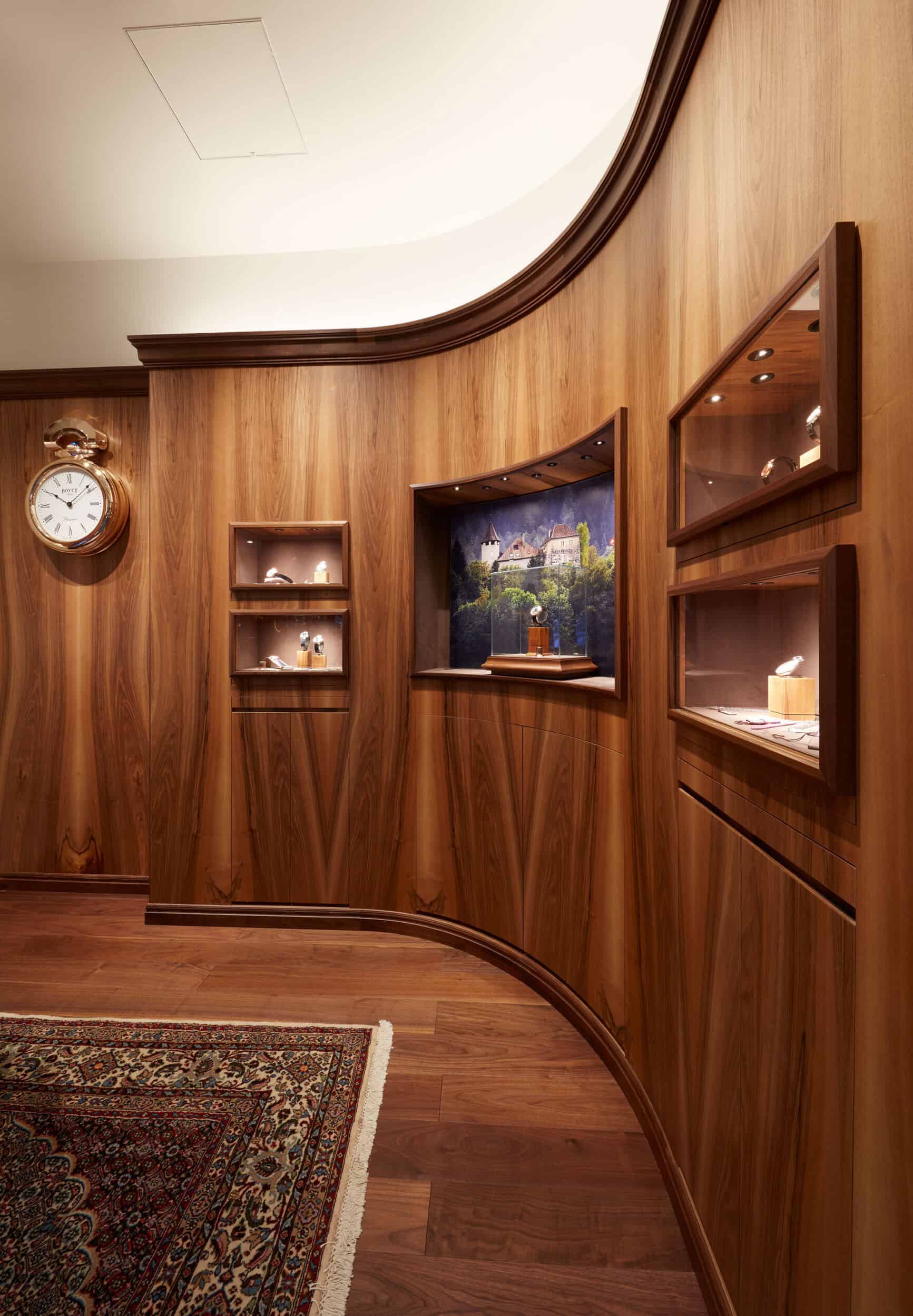 Elegant interior display of Bovet timepieces in a warm wooden setting at BOVET Tokyo.