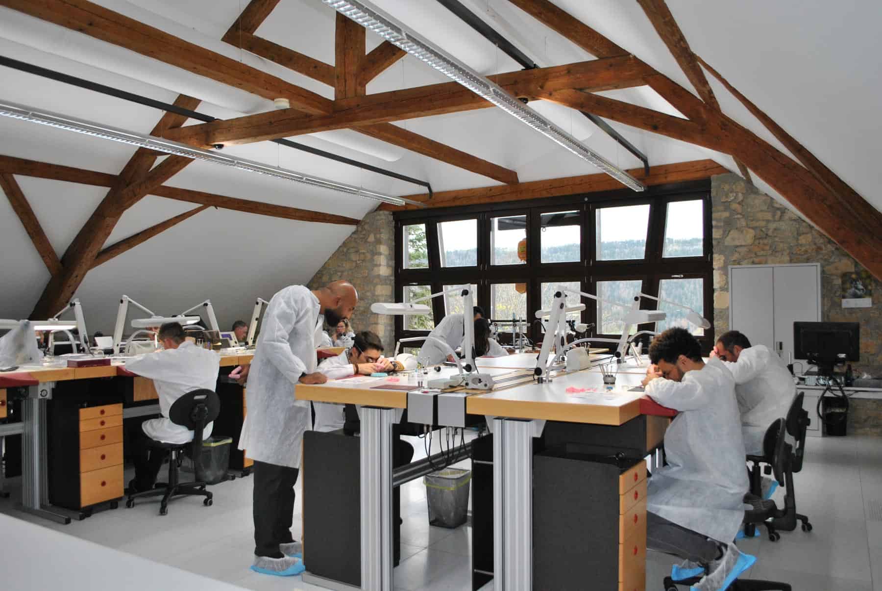 Meticulous artisans assembling intricate timepieces in BOVET's manufacturing workshop.