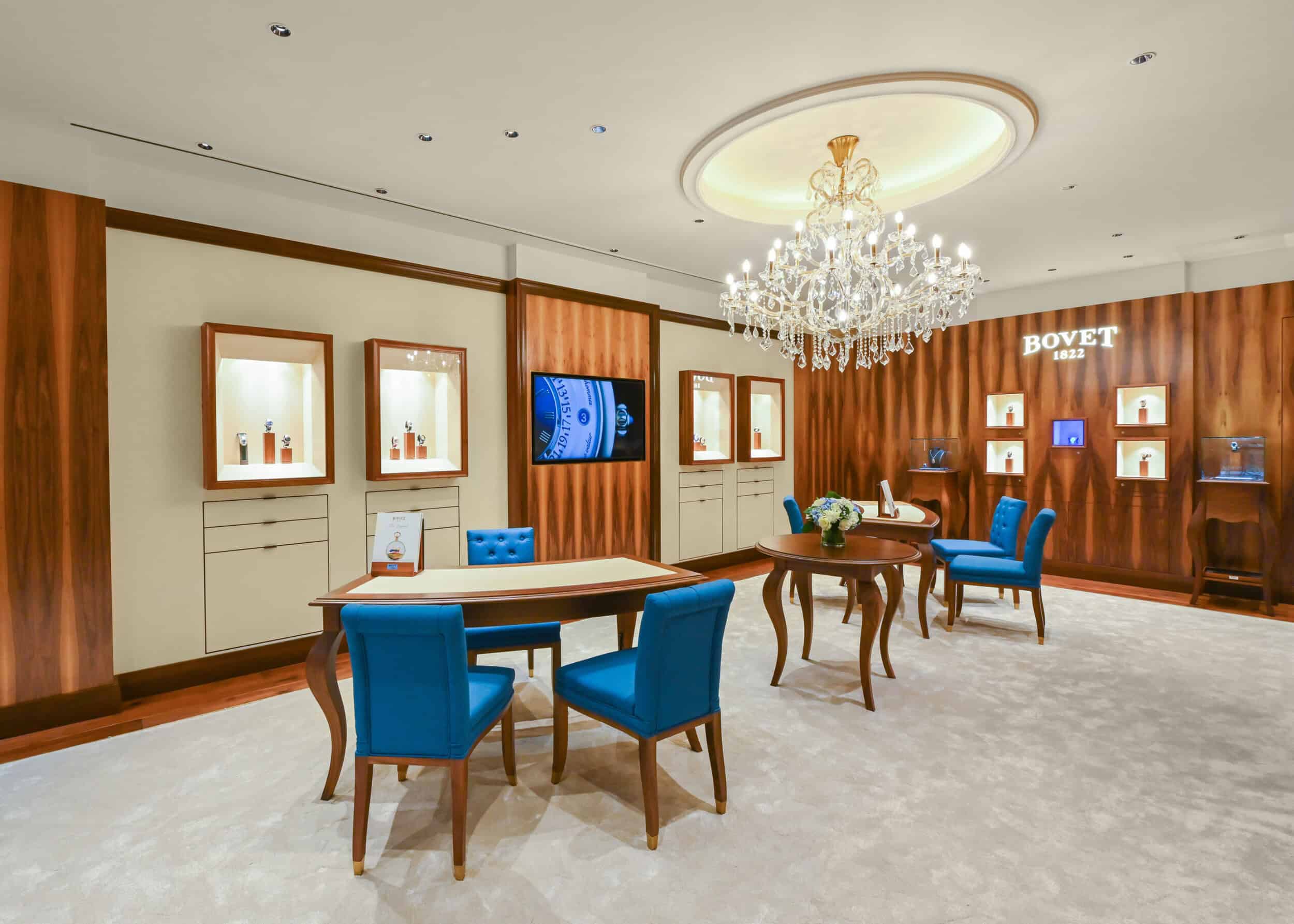 Elegant Bovet showroom in New Delhi featuring luxurious timepieces displayed on illuminated shelves,.