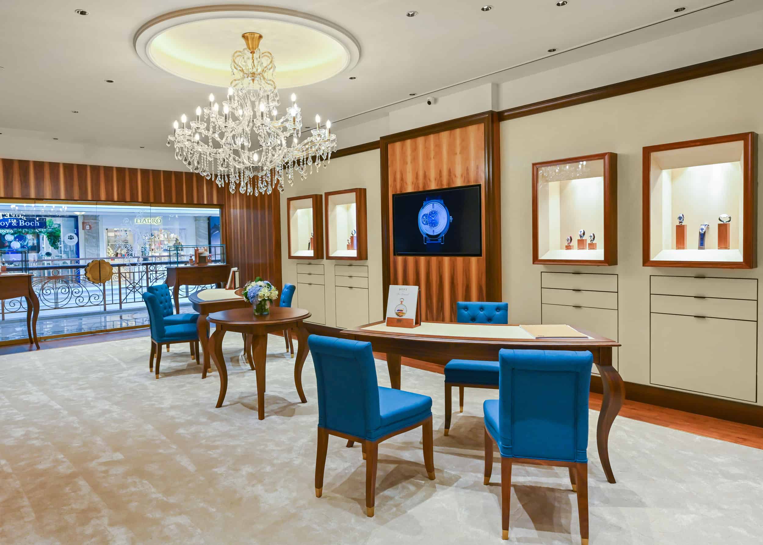 Elegant Bovet display area with luxurious furniture and a chandelier, showcasing exquisite timepiece.