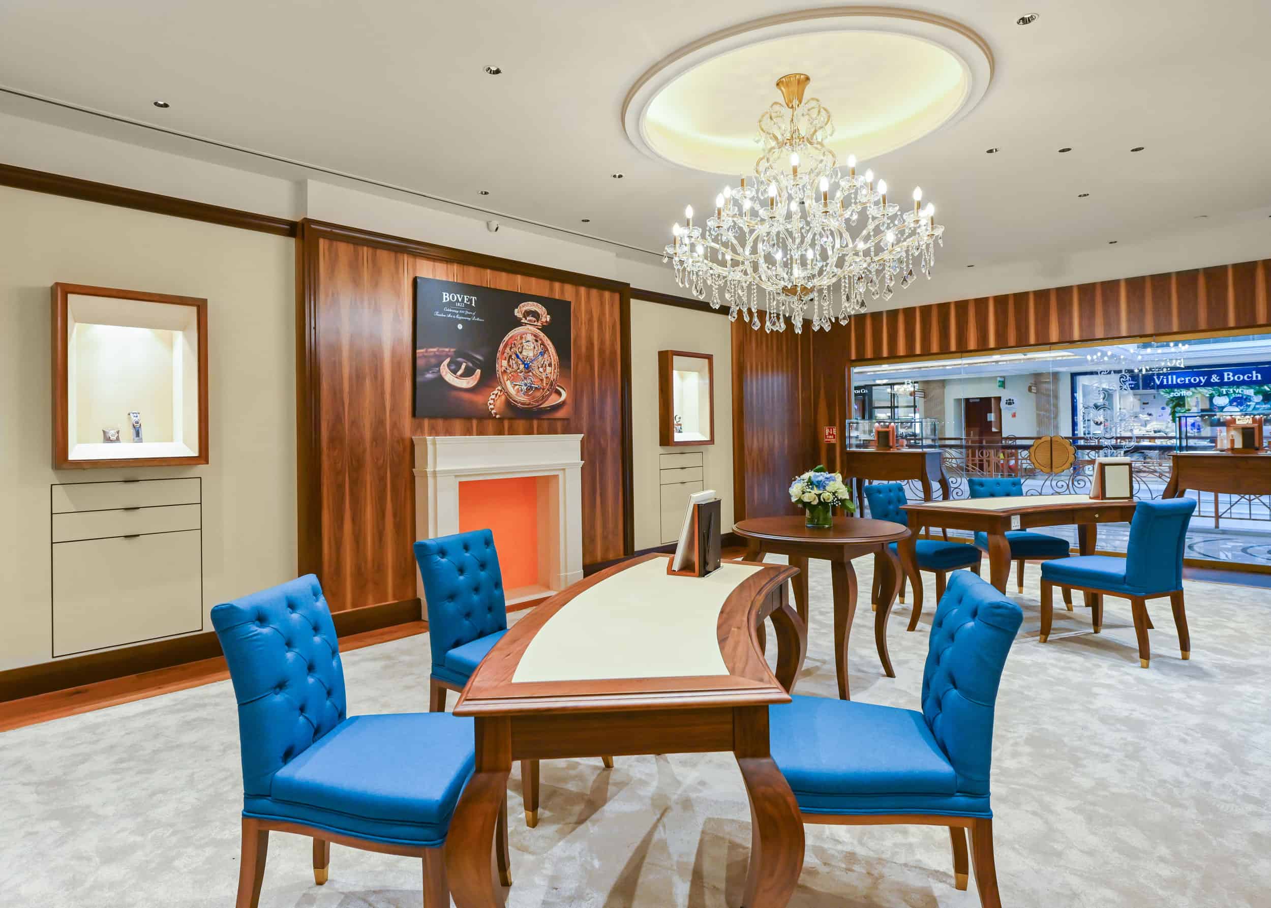 Elegant Bovet display area with luxurious decor and a chandelier, showcasing exquisite timepieces in.
