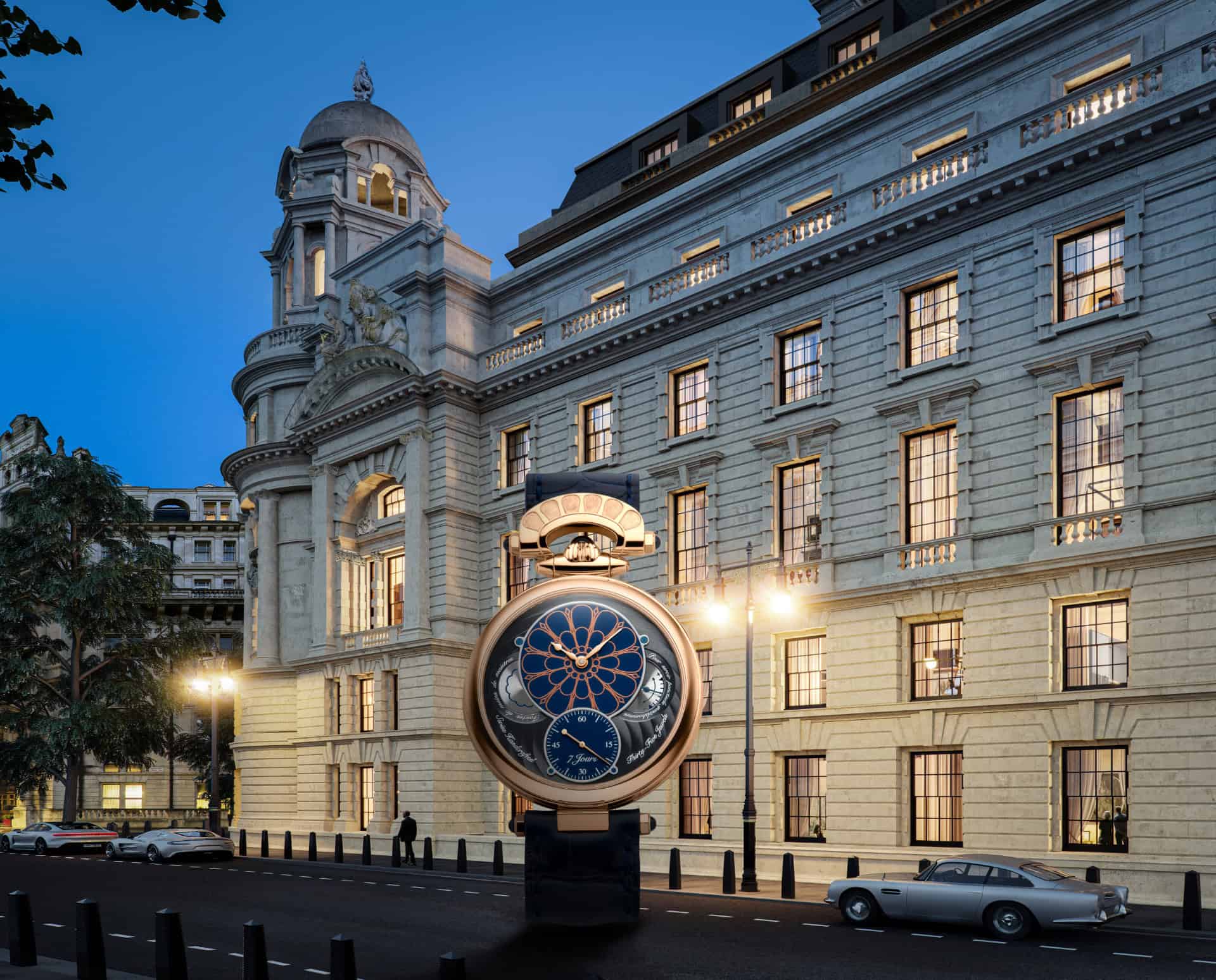 Elegant Bovet timepiece displayed outside historic building at dusk.