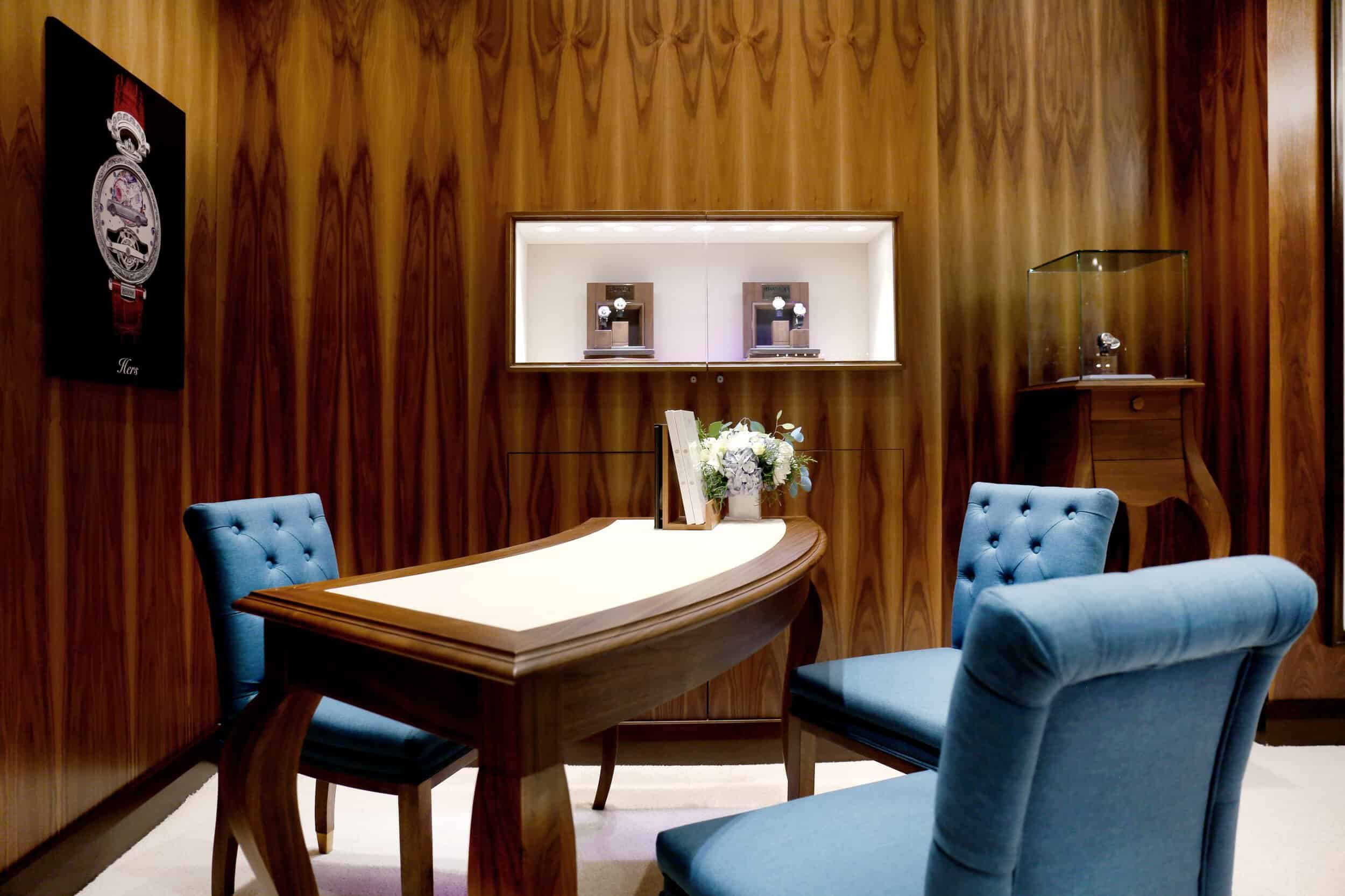 Elegant interior with a wooden wall, showcasing a luxurious Bovet timepiece display in a sophisticat.