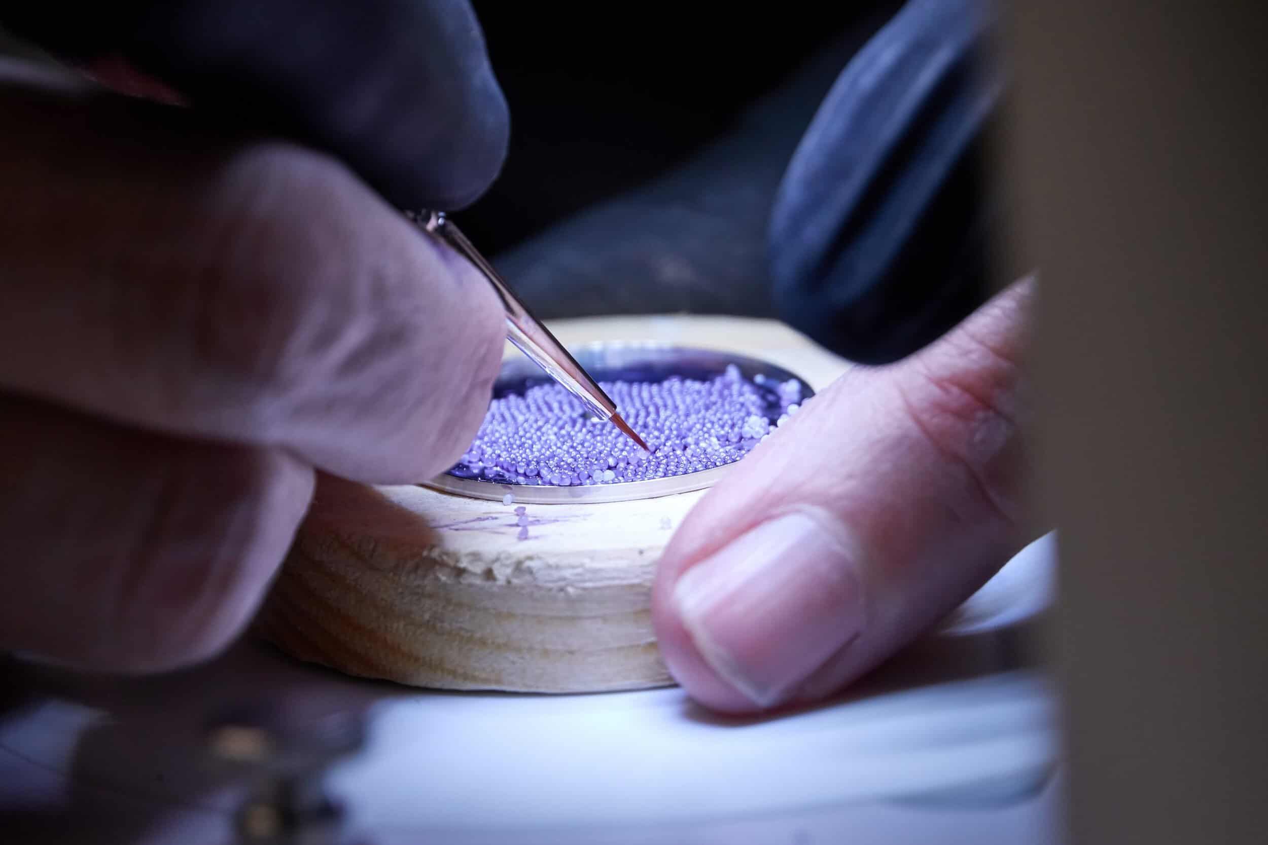 A detailed close-up of a craftsman working on a BOVET timepiece, showcasing precision and craftsmans.