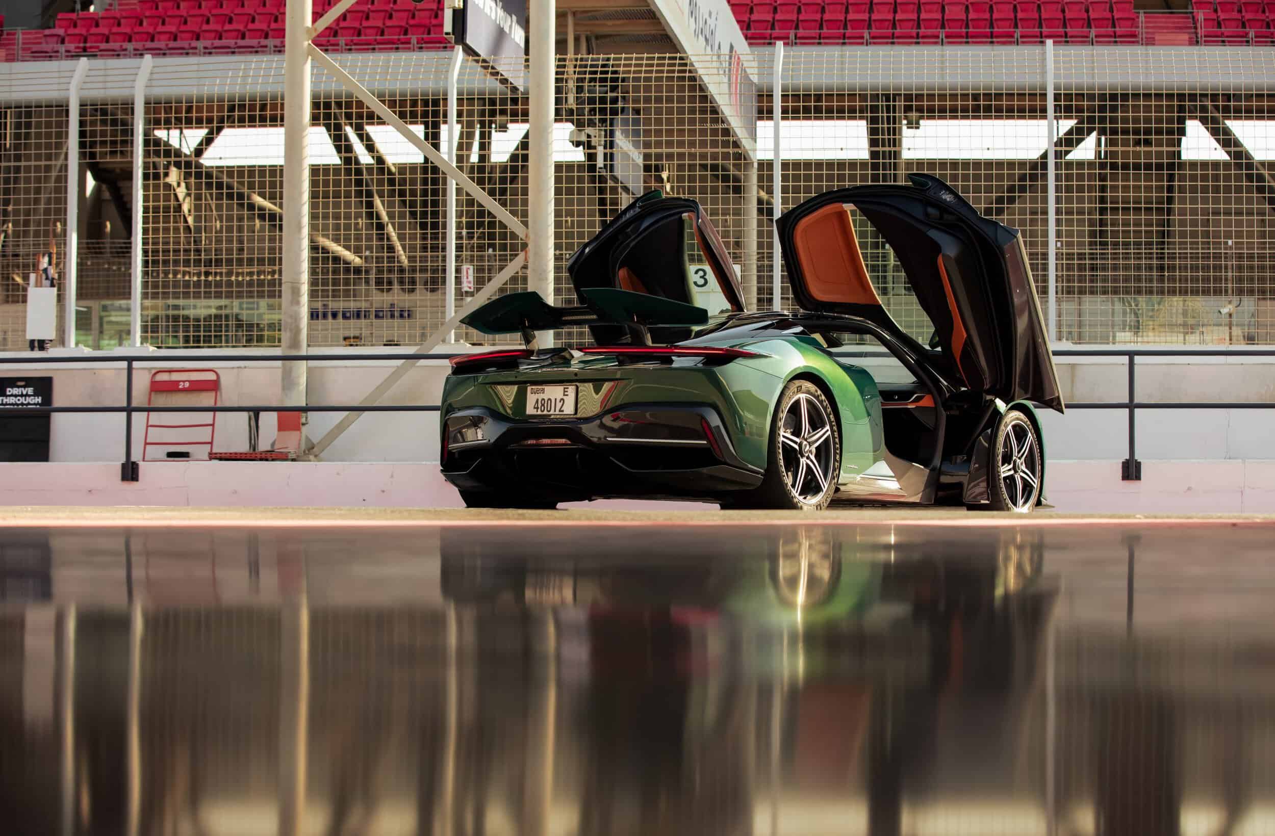 Exquisite Bovet timepiece showcased alongside a sleek sports car at the racetrack.