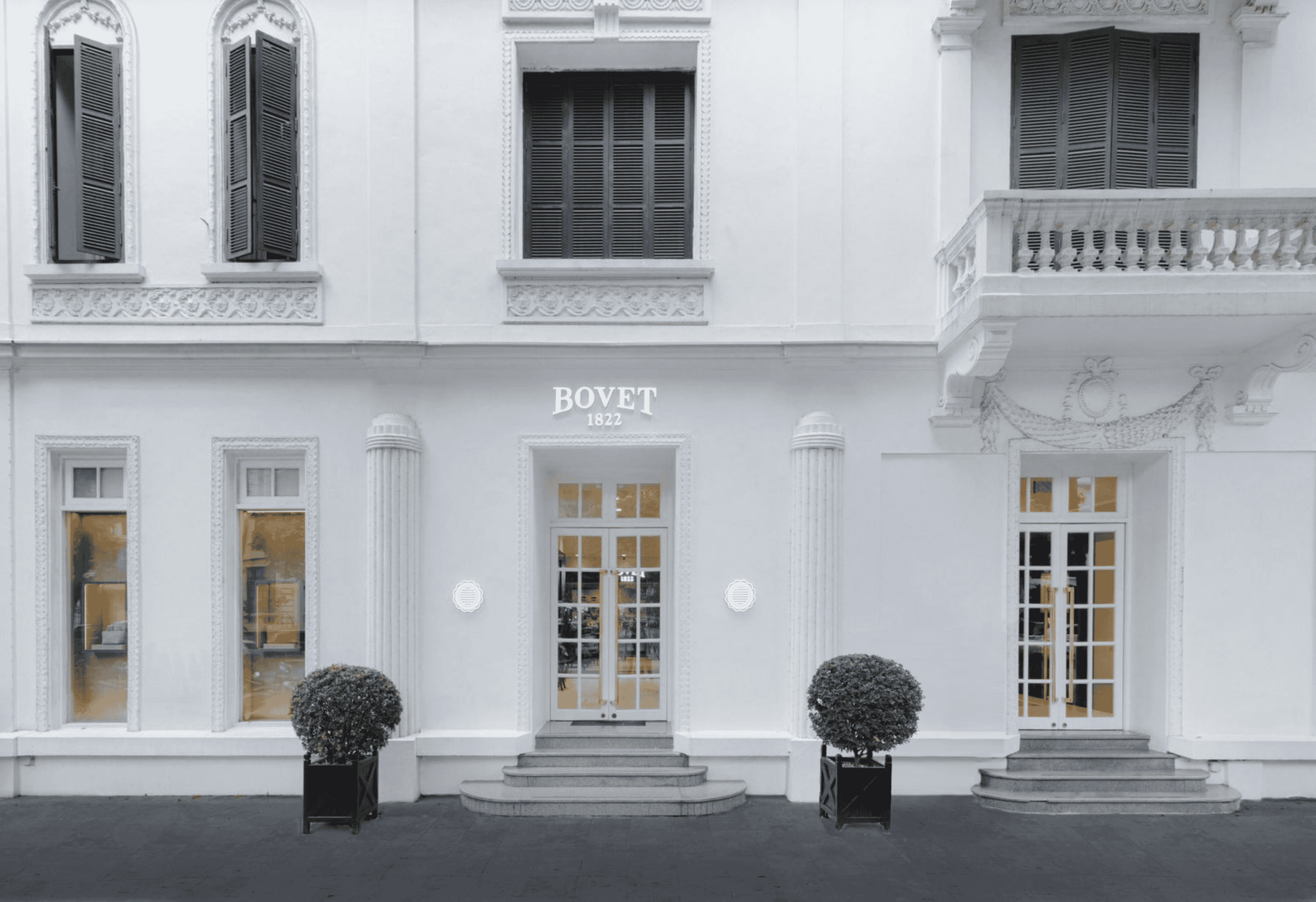 Elegant Bovet storefront showcasing luxury timepieces in a classic white facade.