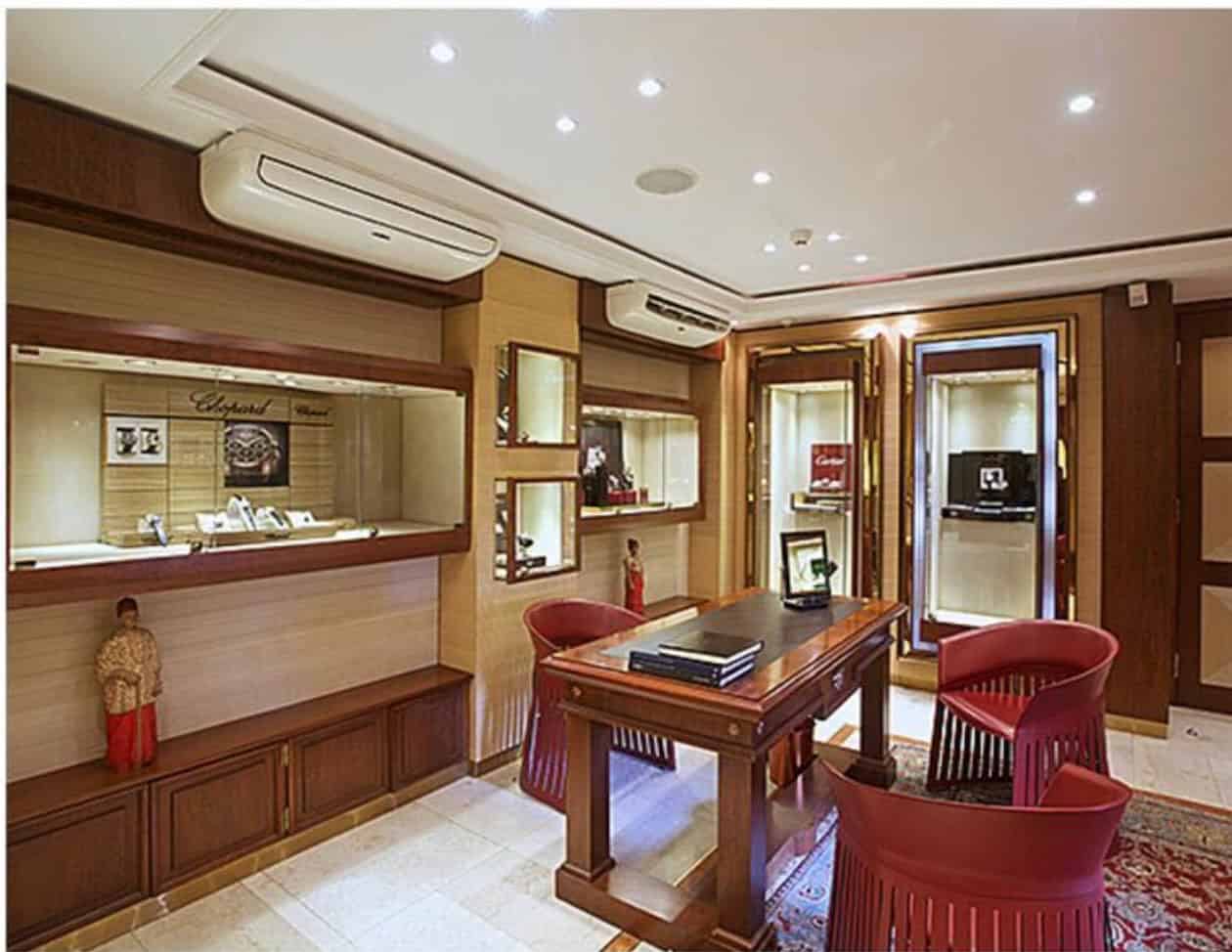 Elegant interior of Polo Towers featuring a luxurious timepiece display area with warm wood accents.