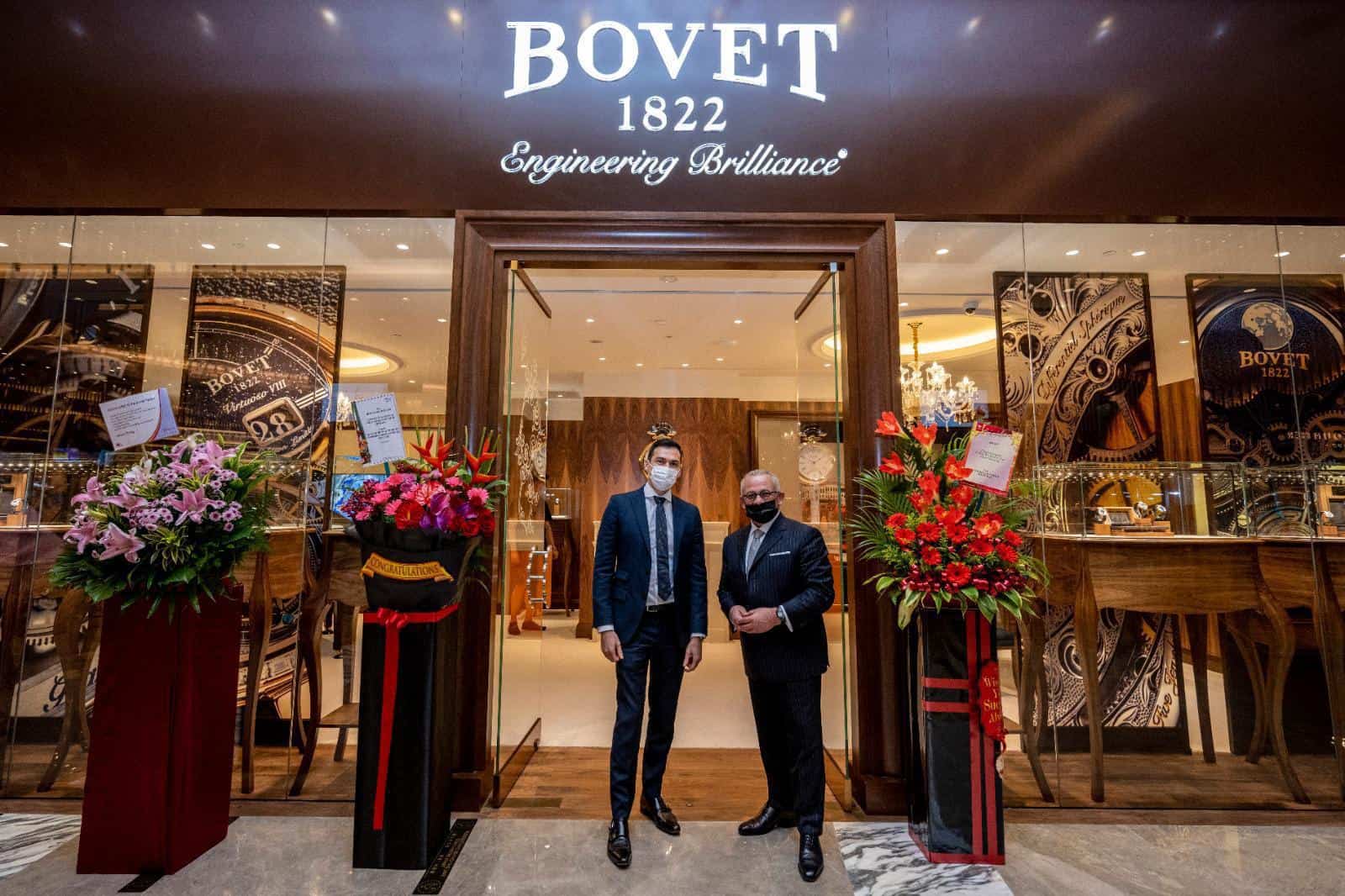 Elegant BOVET boutique entrance in Singapore showcasing luxury timepieces with floral arrangements a.
