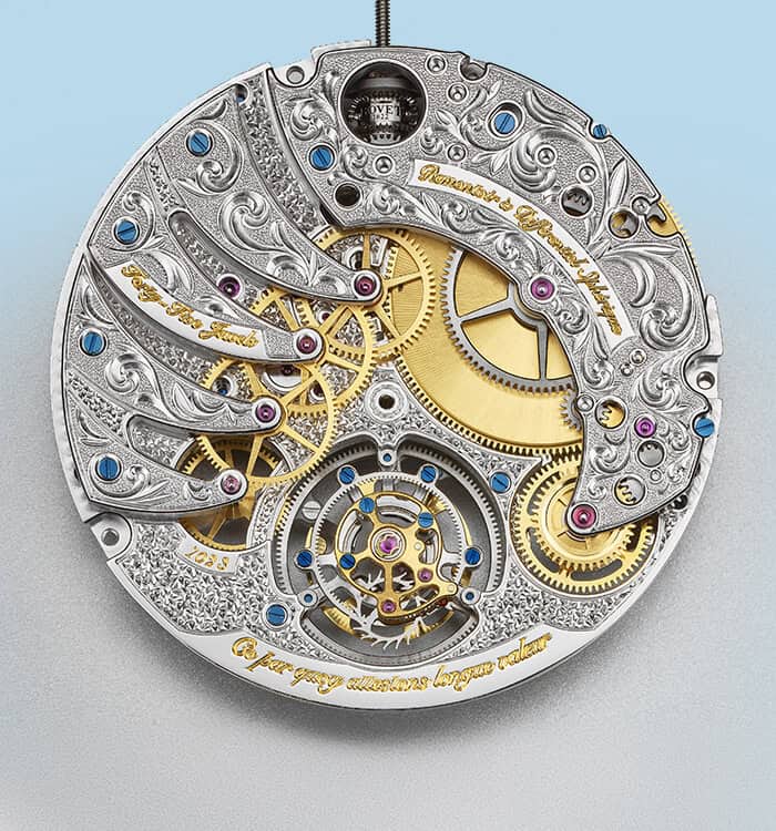 Intricate mechanical movement of a luxury timepiece with detailed engravings and gold accents.