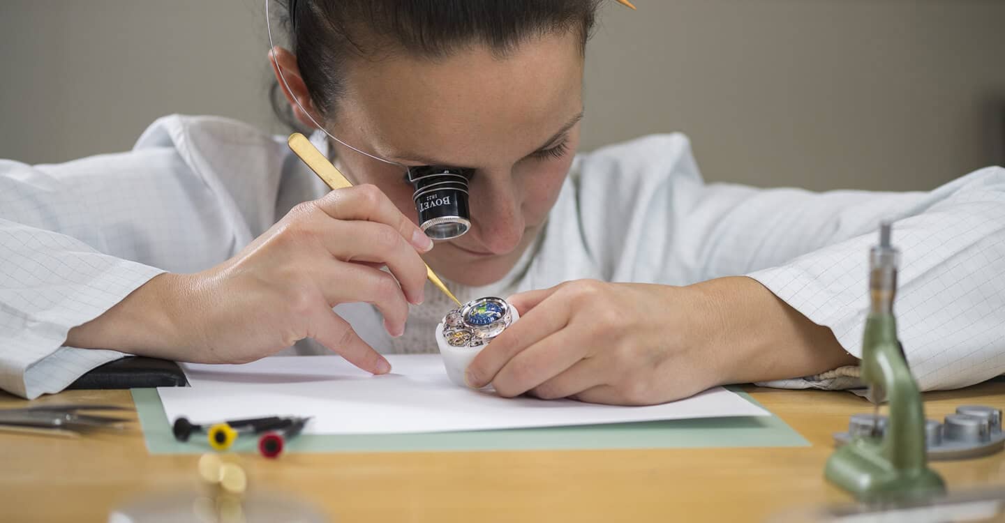 Precision craftsmanship of a Bovet timepiece being assembled by a watchmaker.