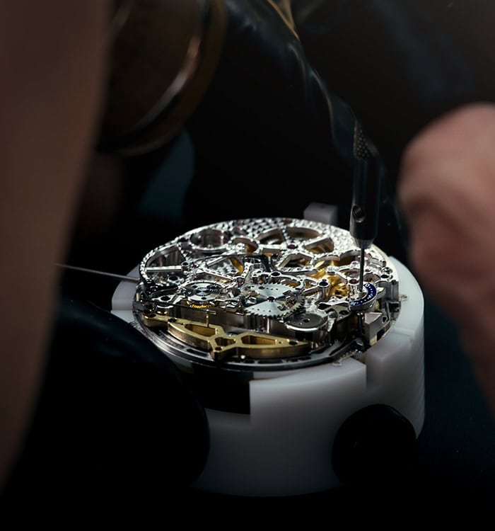 Intricate timepiece movement assembly showcasing craftsmanship and precision engineering.