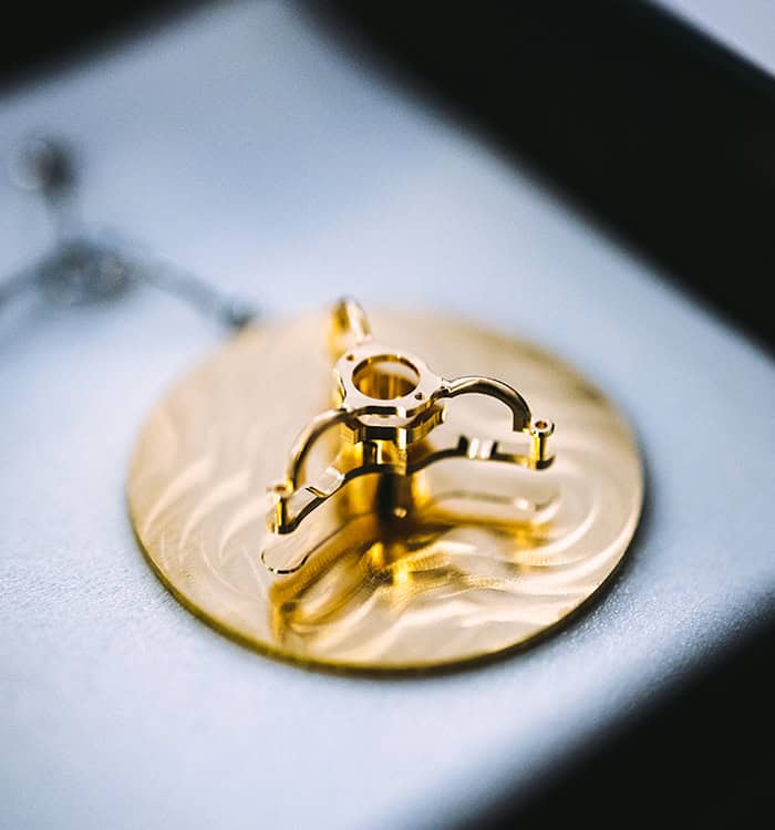 Close-up of a luxurious gold timepiece component from House of Bovet.