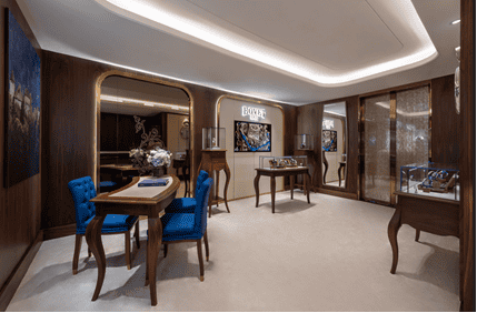 Elegant Bovet display area showcasing luxurious timepieces in a sophisticated hotel lobby setting.
