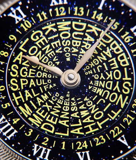 Intricate celestial-inspired timepiece dial with city names and starry background, emphasizing craft.
